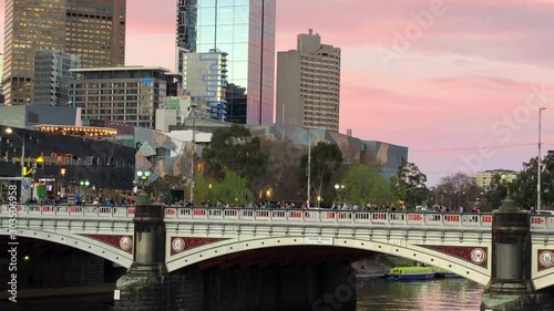 Crowds Of People Walking Over The Southgate Footbridge In Melbourne Australia At Sunset With Pink Sky photo