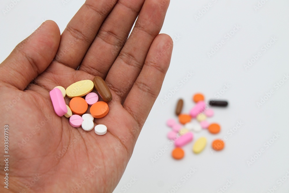colorful and various pills on hand colorful and various pills on hand
