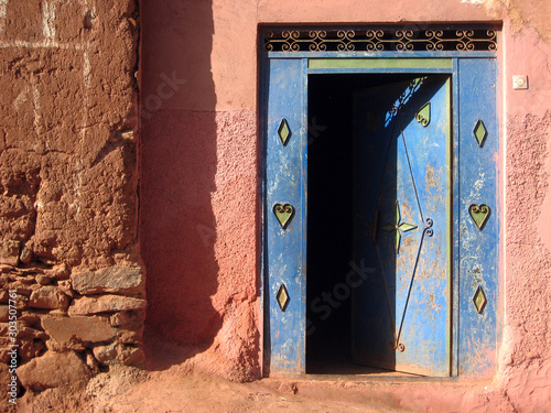 Blue door in adobe Berber house, Altlas mountains, Morocco photo