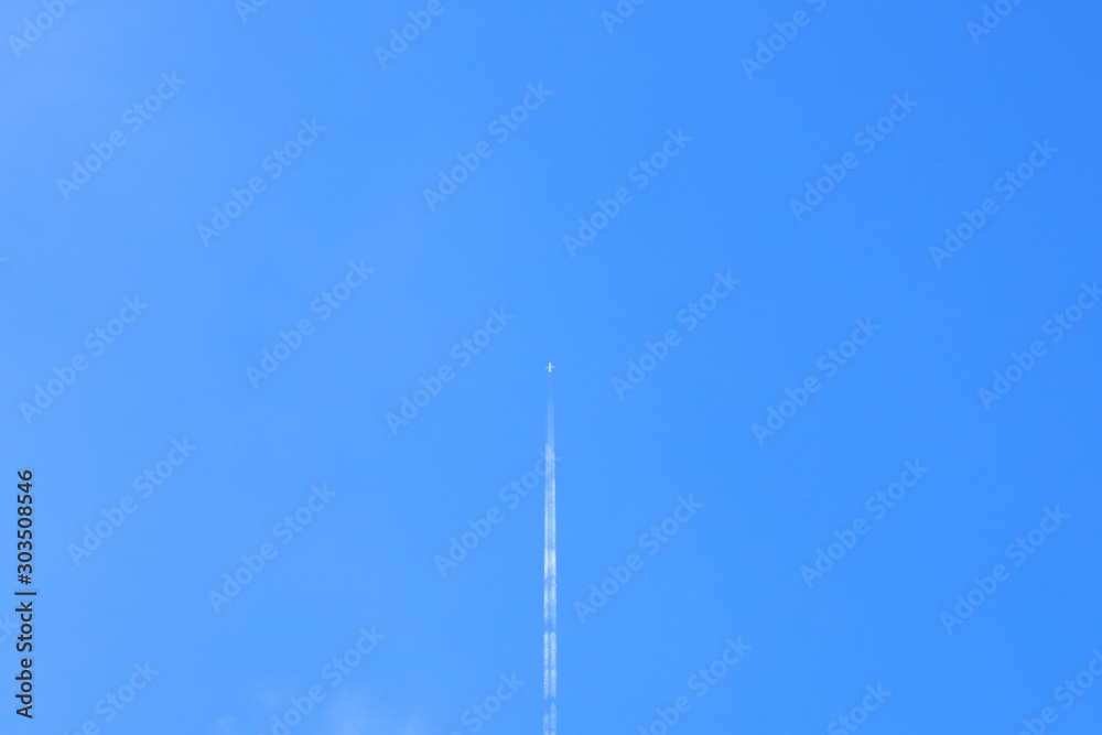 Small white plane with white smoke trail on the blue sky. Small white plane with white smoke trail on the blue sky.