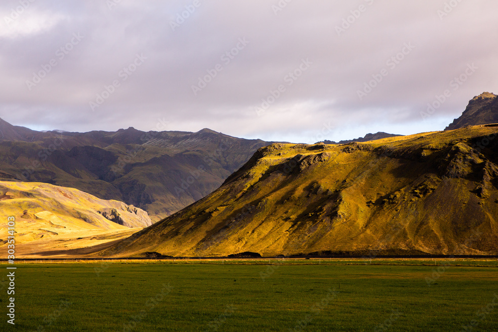 Colorful autumn nature. Travel to Iceland. Beautiful Icelandic landscape with mountains, sky and clouds.