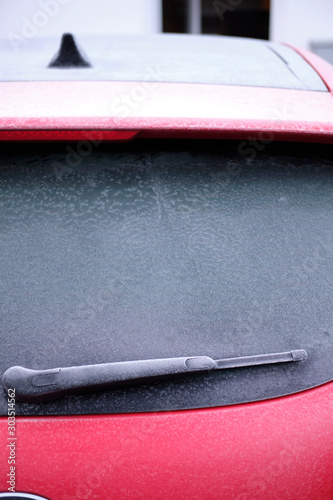 Red car. Winter is the season of cold weather, frosty patterns on glass.