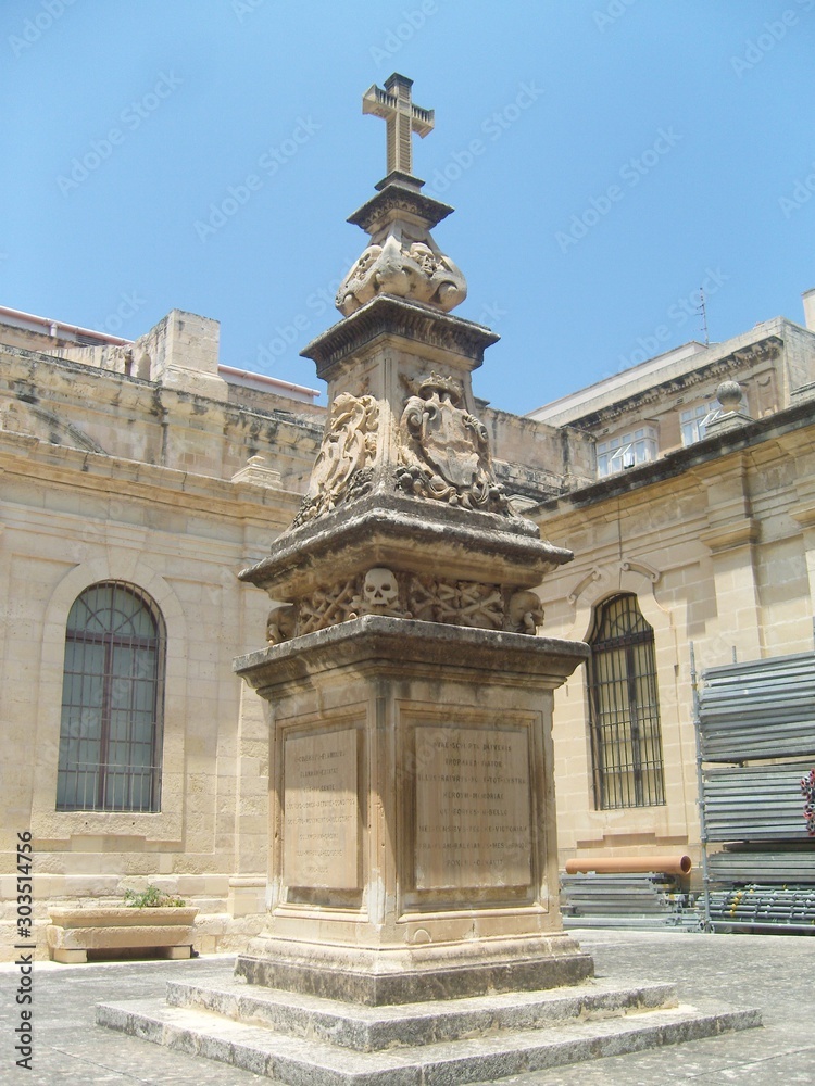 Malta La Valletta monument with skulls and cross in inner courtyard