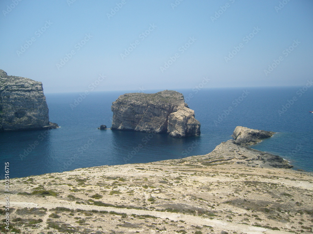 Malta island Gozo steep rocky shore and mediterranean sea in summer