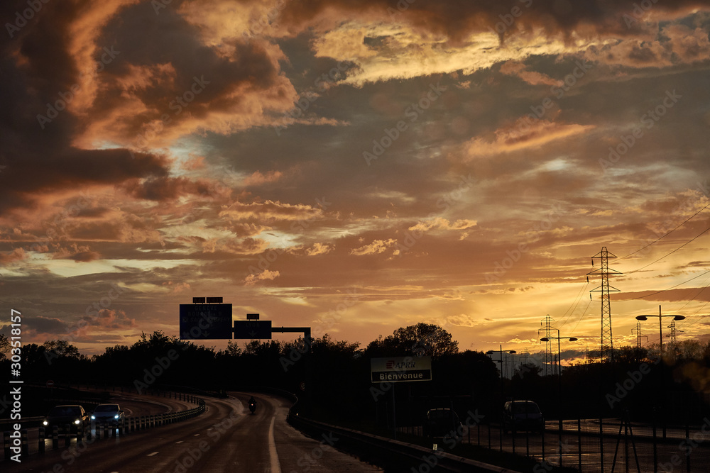 A sunset after the storm on a highway in Lyon. France