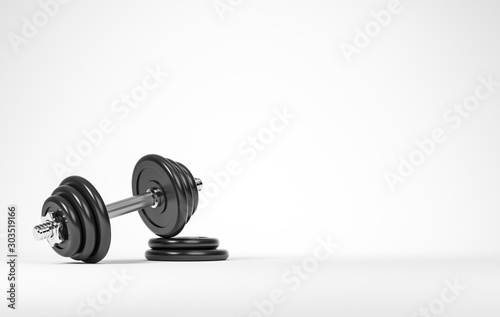 Heavy black professional dumbbell for fitness and bodybuilding with two weight plates on the white background.