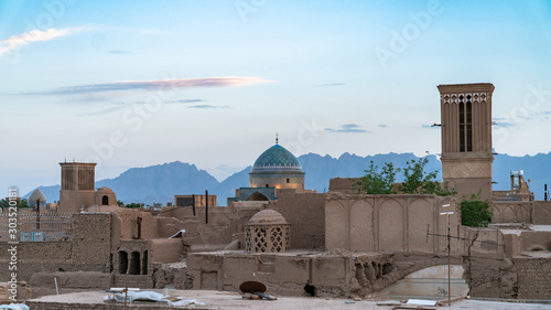 Yazd cityscape with old brick buildings and badgirs wind catching towers in Yazd, Iran. photo
