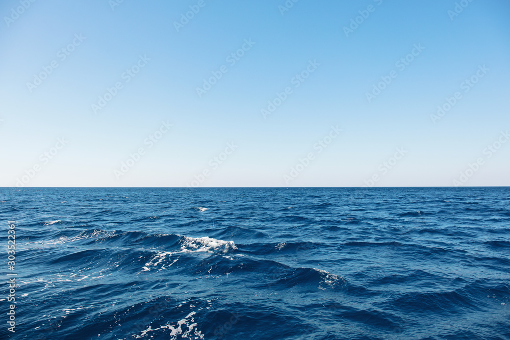 Blue sea surface with waves and horizon