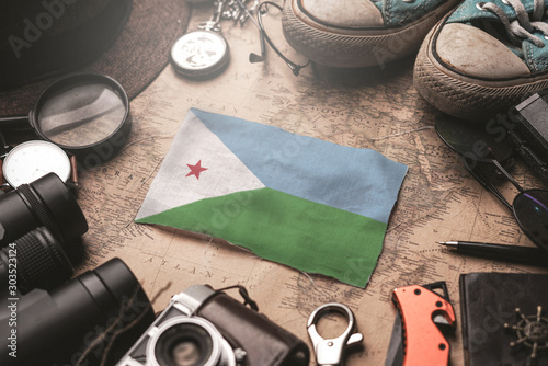 Djibouti Flag Between Traveler's Accessories on Old Vintage Map. Tourist Destination Concept.