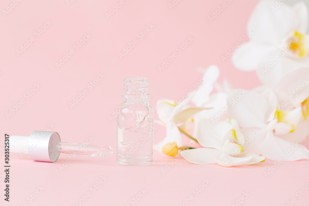 Beauty concept, natural cosmetic products, face and body care. Orchid extract. White cosmetic bottle, White Phalaenopsis orchid flowers on pink background. Natural organic beauty product concept Beauty concept, natural cosmetic products, face and body care. Orchid extract. White cosmetic bottle, White Phalaenopsis orchid flowers on pink background. Natural organic beauty product concept