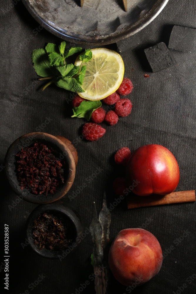 bowl with tobacco for hookah. fruits on a dark background. smoking nargile bowl with tobacco for hookah. fruits on a dark background. smoking nargile