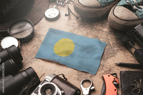 Palau Flag Between Traveler's Accessories on Old Vintage Map. Tourist Destination Concept.