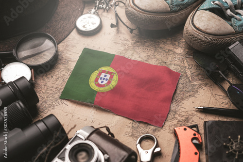 Portugal Flag Between Traveler's Accessories on Old Vintage Map. Tourist Destination Concept.