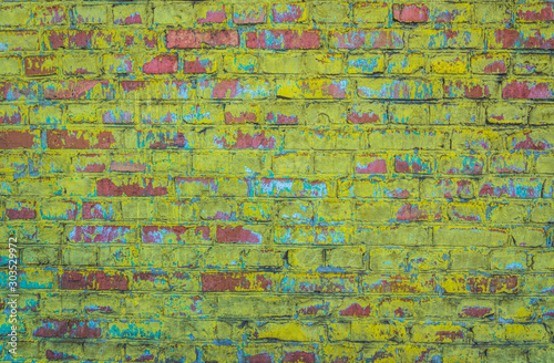 Old weathered brick wall. Peeling cracked paint on red brick © konoplizkaya