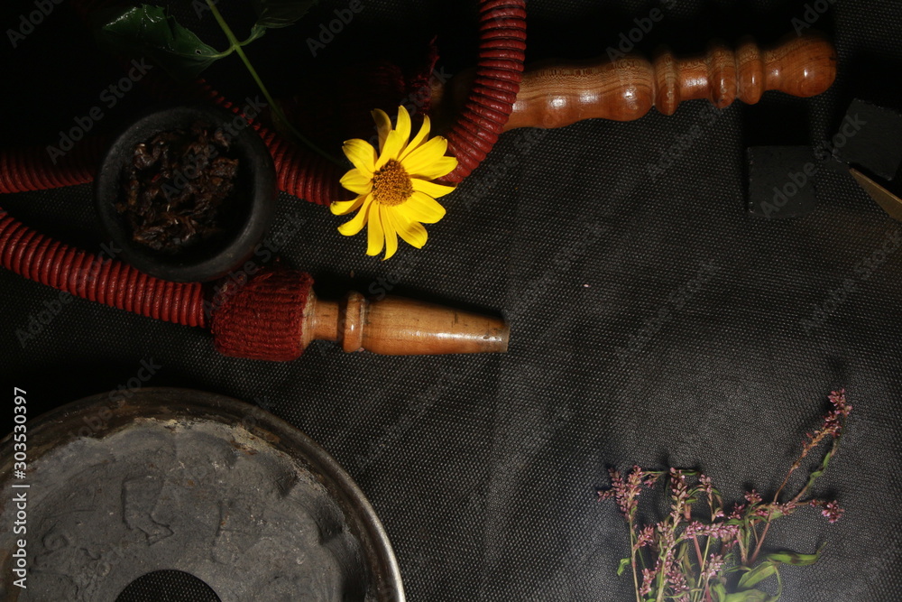 bowl with tobacco for hookah. fruits on a dark background. smoking shiisha
