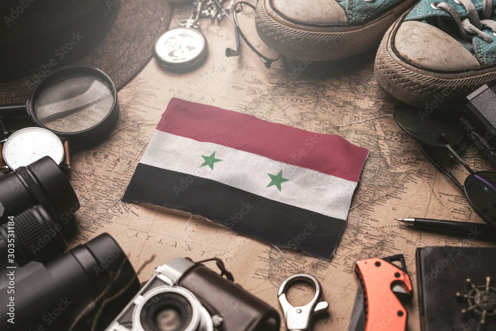 Syria Flag Between Traveler's Accessories on Old Vintage Map. Tourist Destination Concept. Syria Flag Between Traveler's Accessories on Old Vintage Map. Tourist Destination Concept.