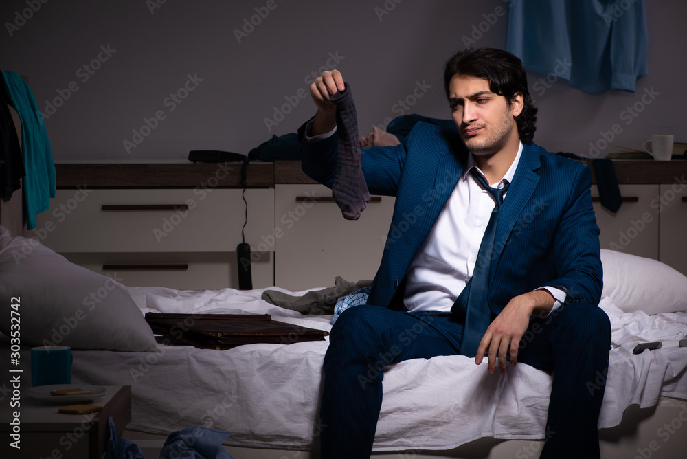 Fototapeta premium Young employee working at home after night shift