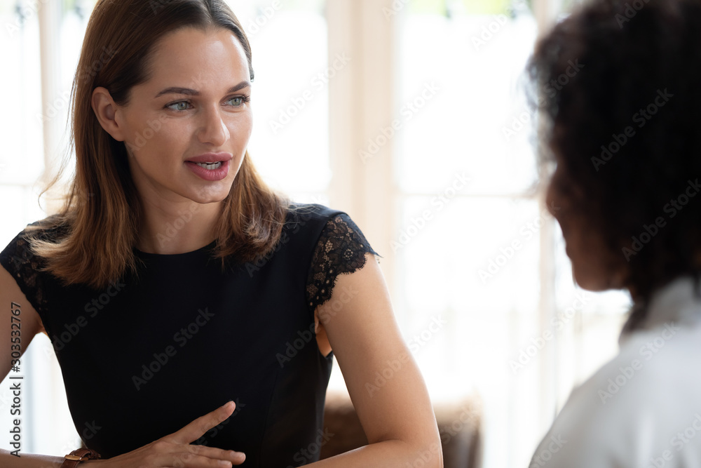 Focused hr manager holding job interview with african american applicant. Focused hr manager holding job interview with african american applicant.