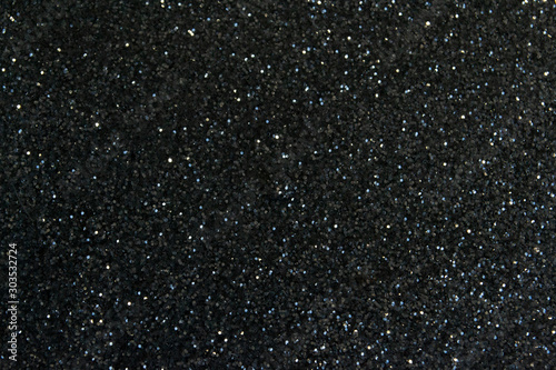 dark background in the form of a scattering of black and silver sequins