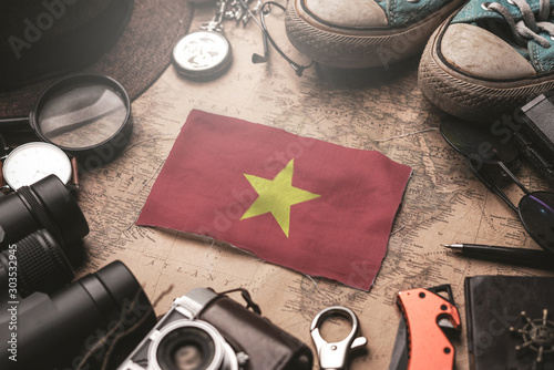Vietnam Flag Between Traveler's Accessories on Old Vintage Map. Tourist Destination Concept.