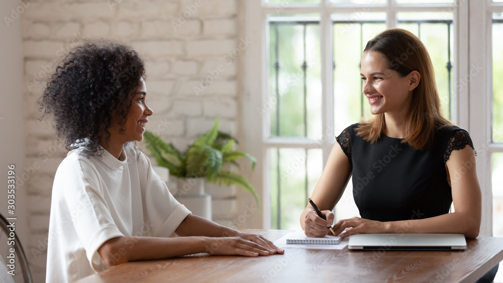 HR manager holding job interview with skilled african ethnicity woman. HR manager holding job interview with skilled african ethnicity woman.