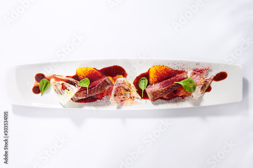 Duck breast with roasted plum dish top view