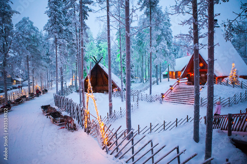 Santa claus village lapland finland. beautiful wooden bridge with lanterns photo