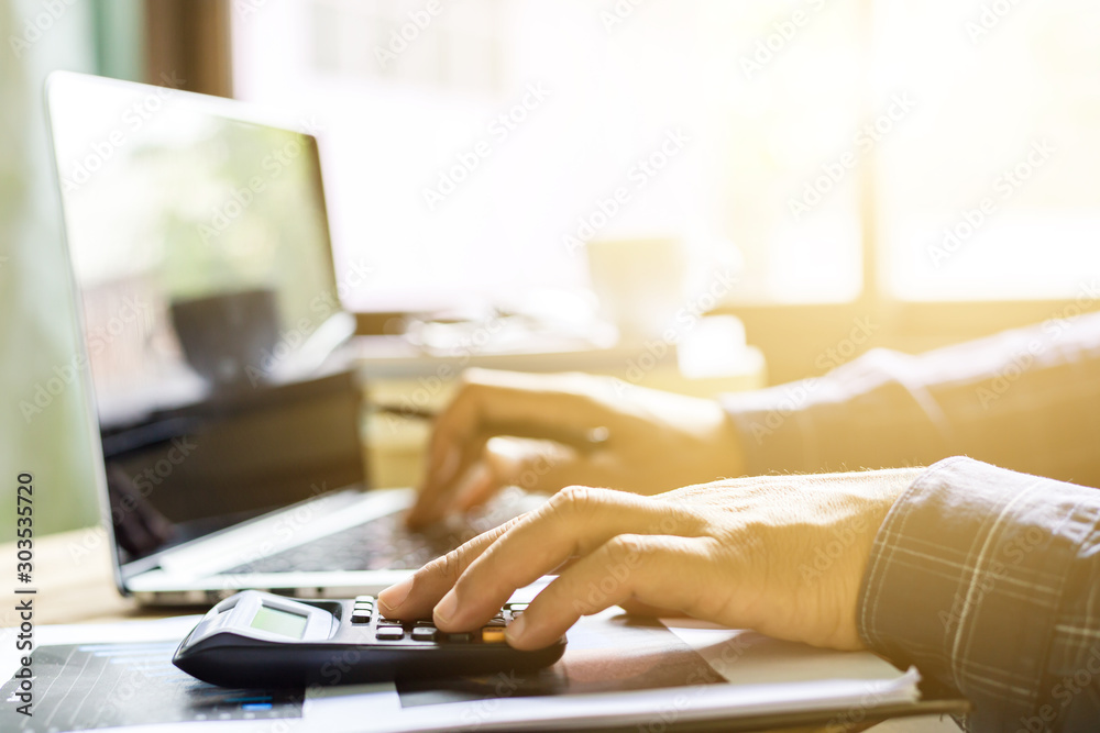 Fototapeta premium Office desk table of modern workplace with laptop on wooden table, top view laptop background and copy space on wooden background, White desk office with laptop, 