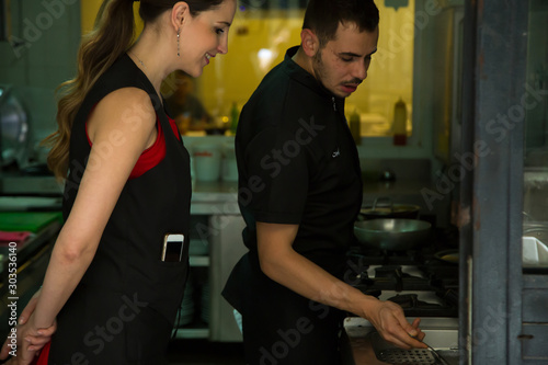 Group of chef preparing food in the kitchen of a restaurant