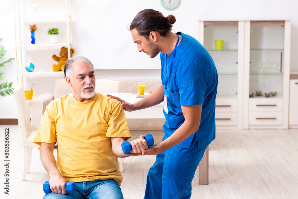 Young male doctor visiting old patient at home Young male doctor visiting old patient at home