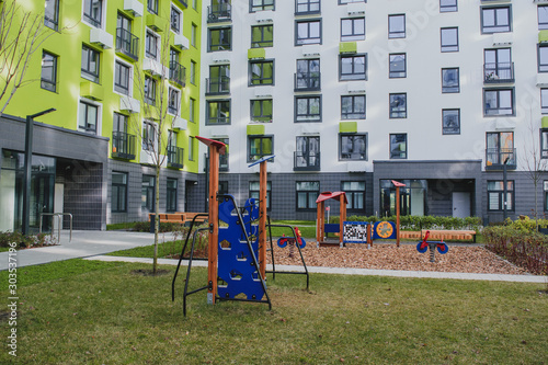 new residential quarter of new buildings: a modern playground in the courtyard of an apartment building with a bright facade 1