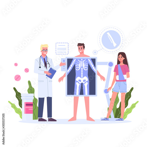 Doctor standing around a big x-ray image of male body.