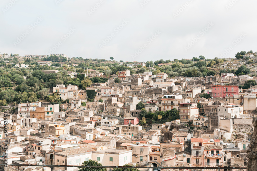sunshine on roofs of old houses in modica, italy