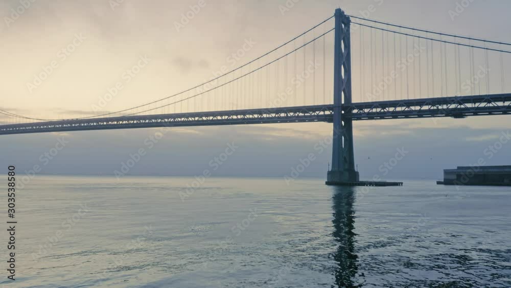 Aerial: San Francisco Bay Bridge and the embarcadero waterfront at sunrise. California, USA Aerial: San Francisco Bay Bridge and the embarcadero waterfront at sunrise. California, USA
