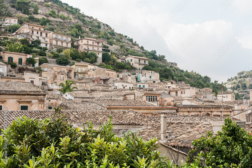 small houses on hill near green plants in modica, italy