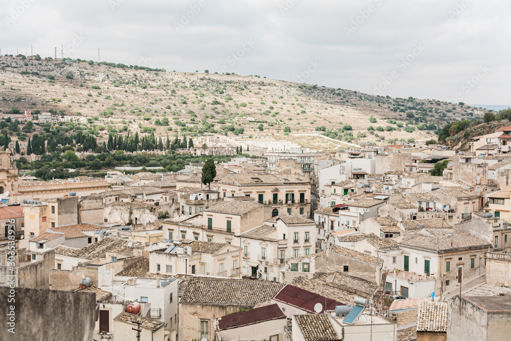 old italian city with small houses against blue sky