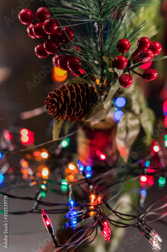  Toys on the Christmas tree. Christmas lights and candles.