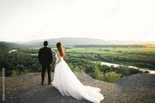 Beautiful wedding couple staying over beautiful landscape