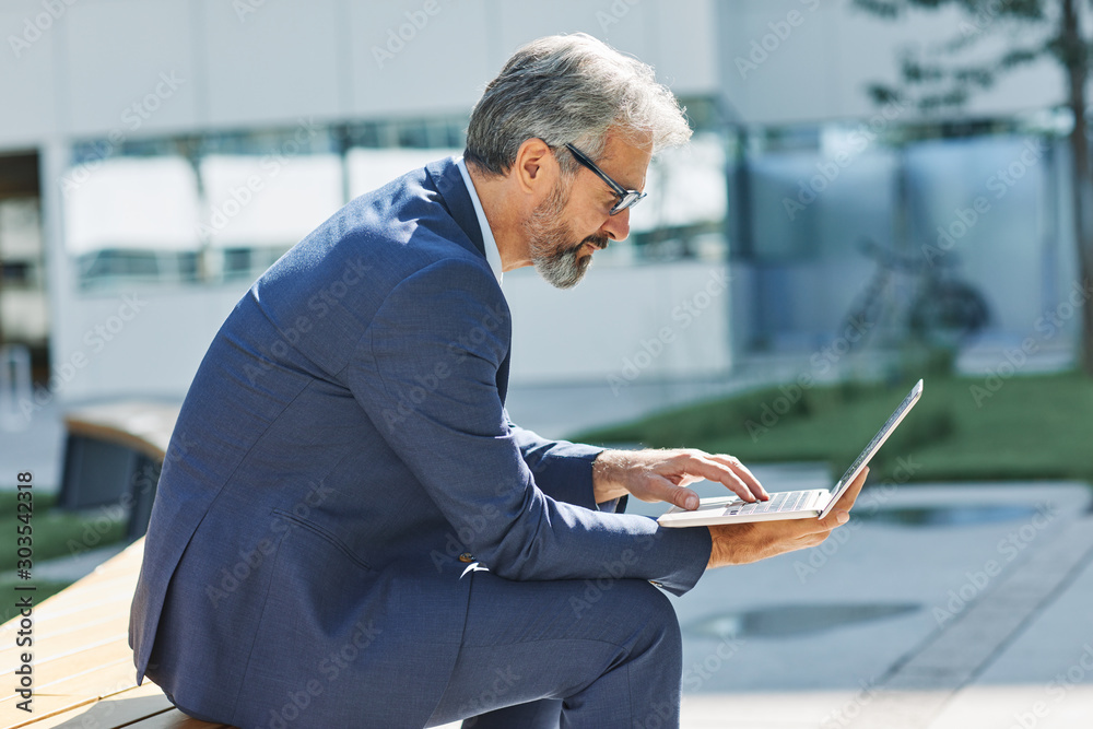senior businessman office building laptop tablet outdoor city senior businessman office building laptop tablet outdoor city