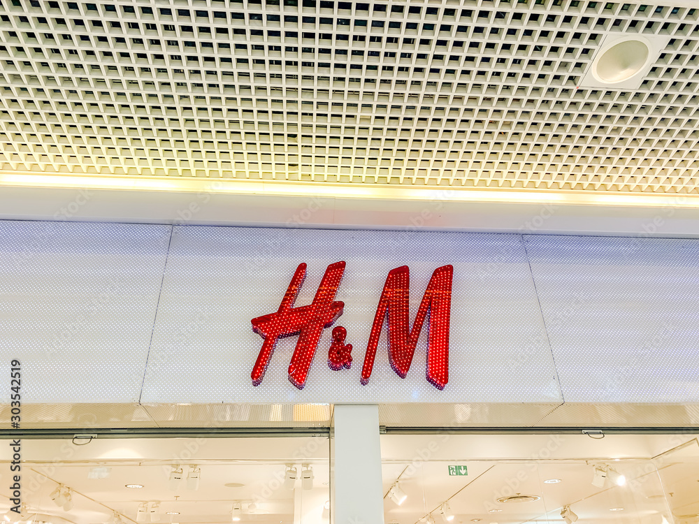 H&M store brand logo in shopping mall Stock Photo | Adobe Stock