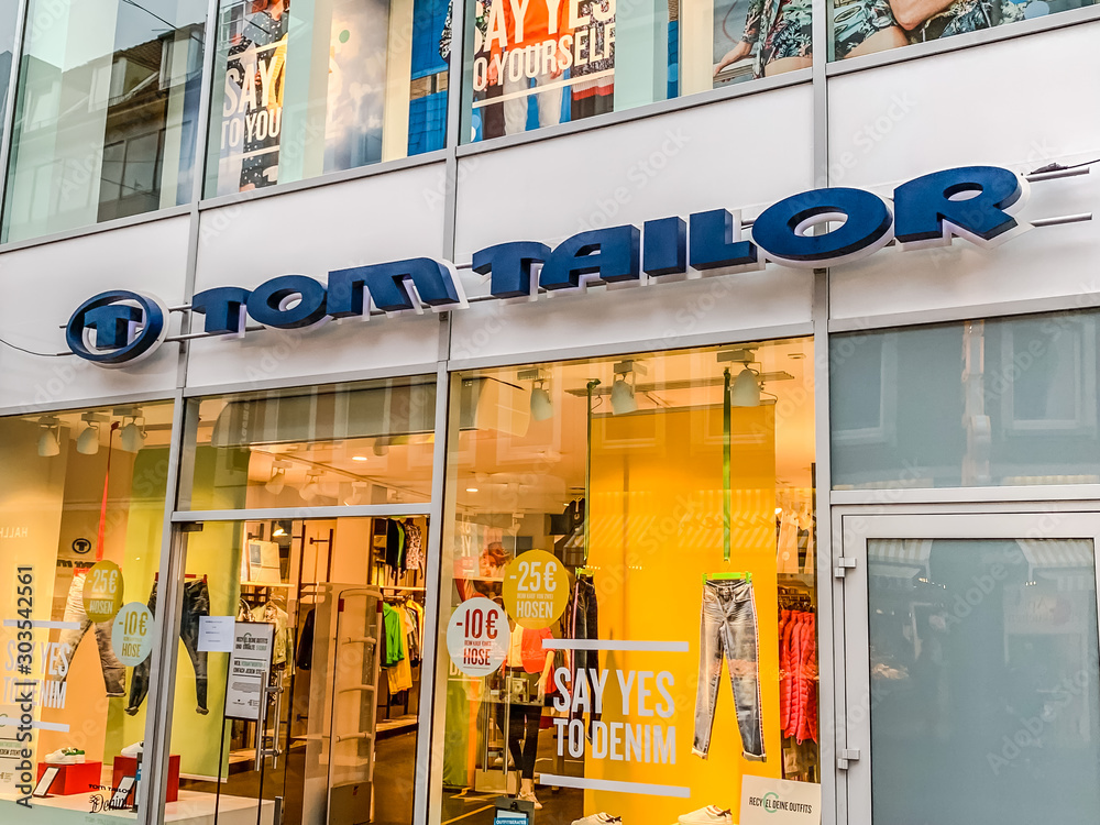 Tom Tailor clothing retail store with brand logo Stock Photo | Adobe Stock