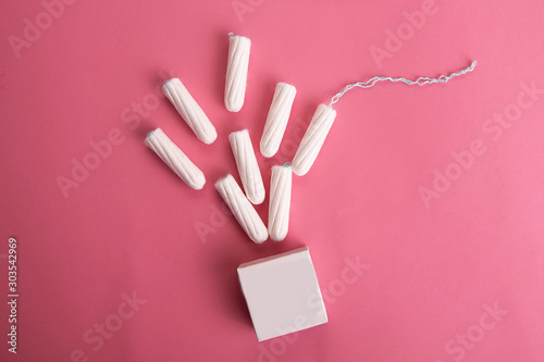 Medical female tampon on a pink background.