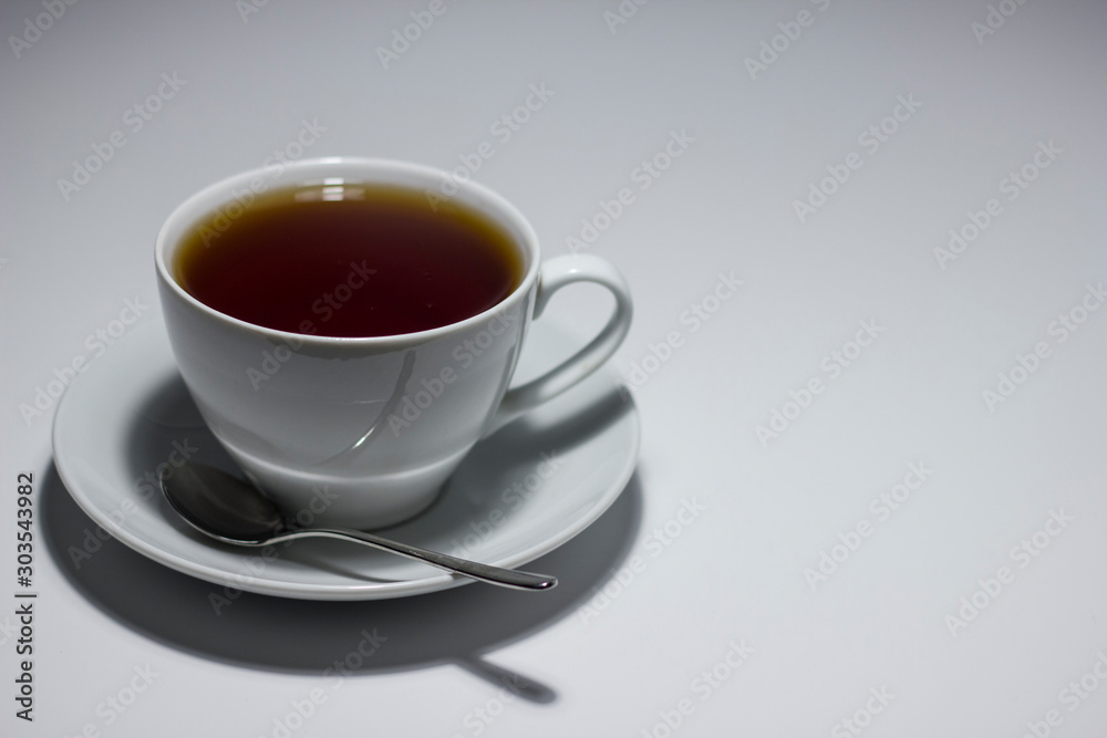 A mug of tea on a saucer. On white background. A mug of tea on a saucer. On white background.