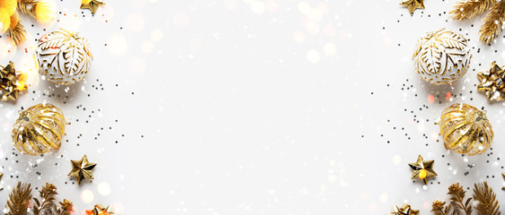 Christmas and New Year holiday background. Xmas greeting card. Christmas golden ornaments on white background top view