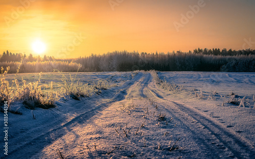 winter sunset over frozen road