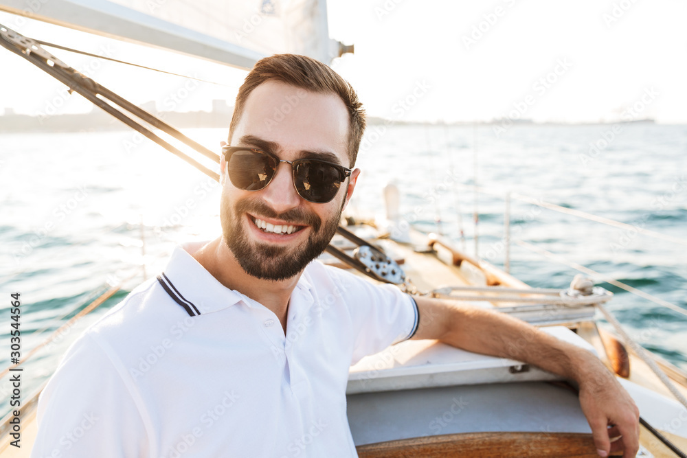 Handsome young amazing man outdoors on yacht in sea. Handsome young amazing man outdoors on yacht in sea.