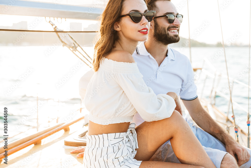 Optimistic pleased young loving couple outdoors Optimistic pleased young loving couple outdoors