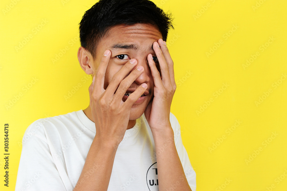 Portrait of young Asian teenager unhappy scared man Portrait of young Asian teenager unhappy scared man