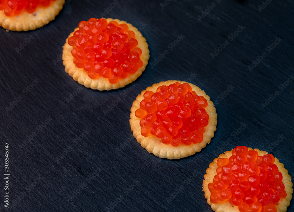 Tartlets with red caviar on dark background Tartlets with red caviar on dark background
