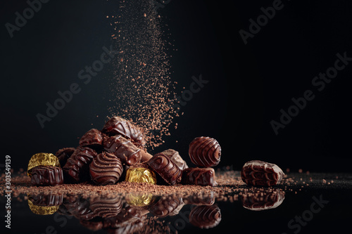Chocolate candies sprinkled with chocolate chips. photo